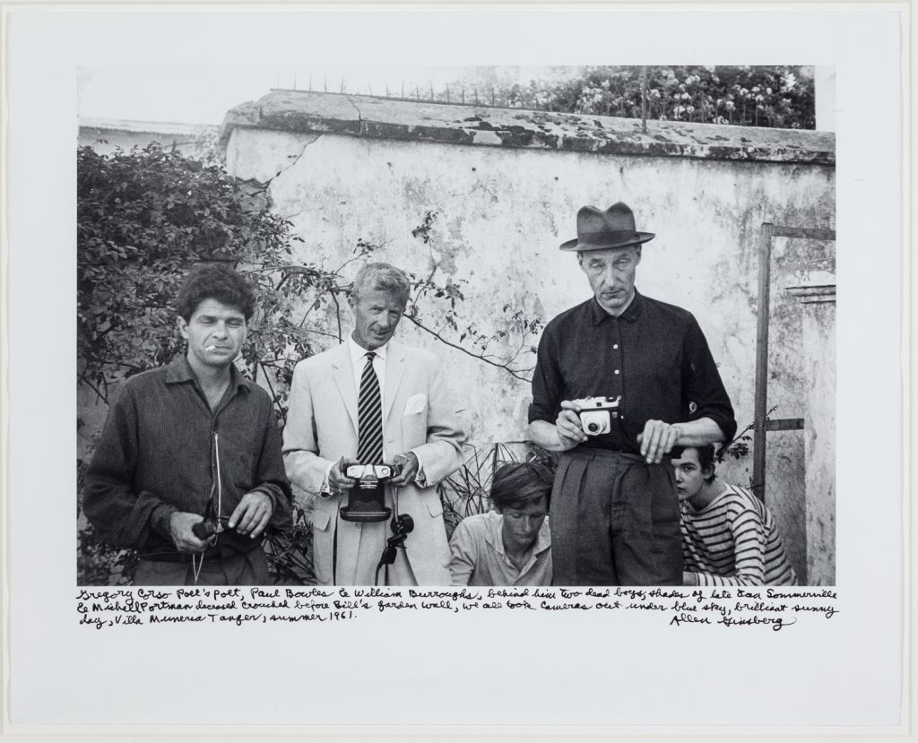 Gregory Corso, Paul Bowles, William Burroughs, Tangier (Michael Portman and Ian Sommerville crouching behind Burroughs), 1961
