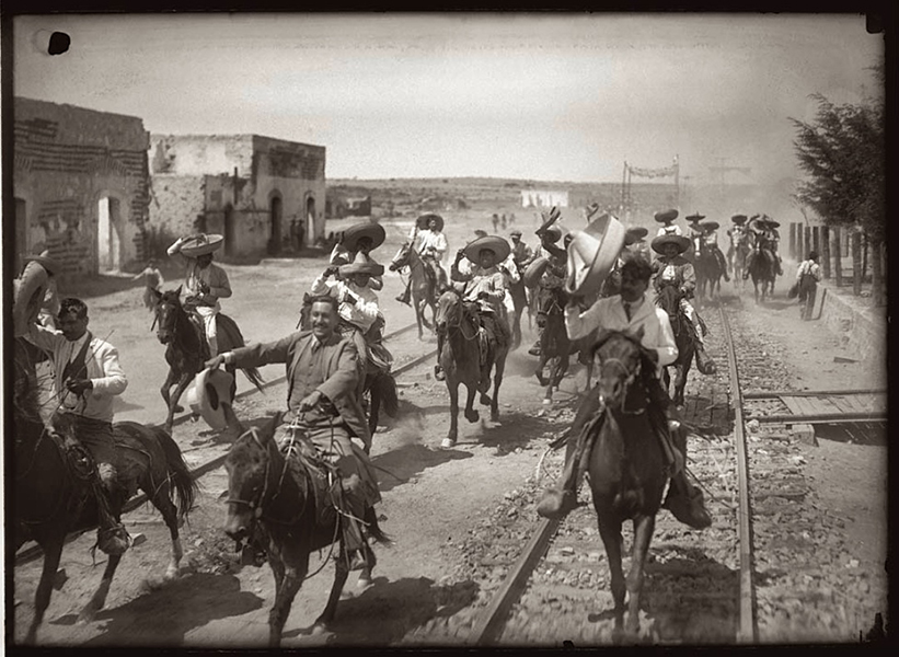Francisco Madero’s troops storming into a town on horseback,Mexico, ca.1911