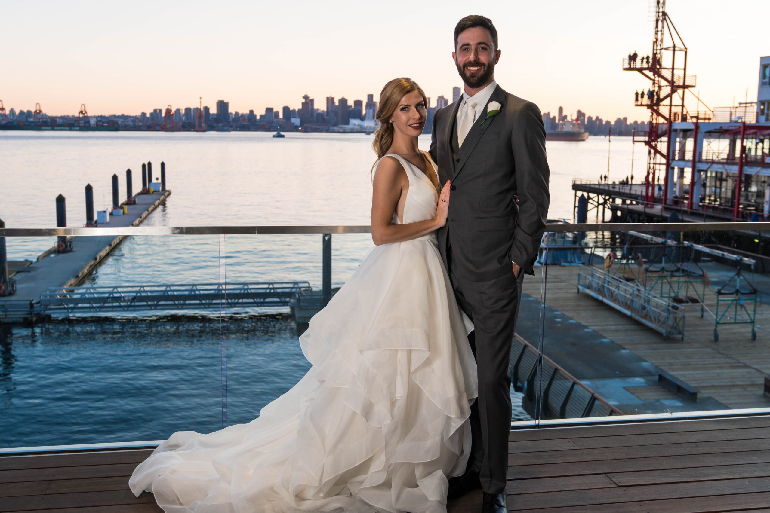 couple on balcony smiling. City View in background jpg